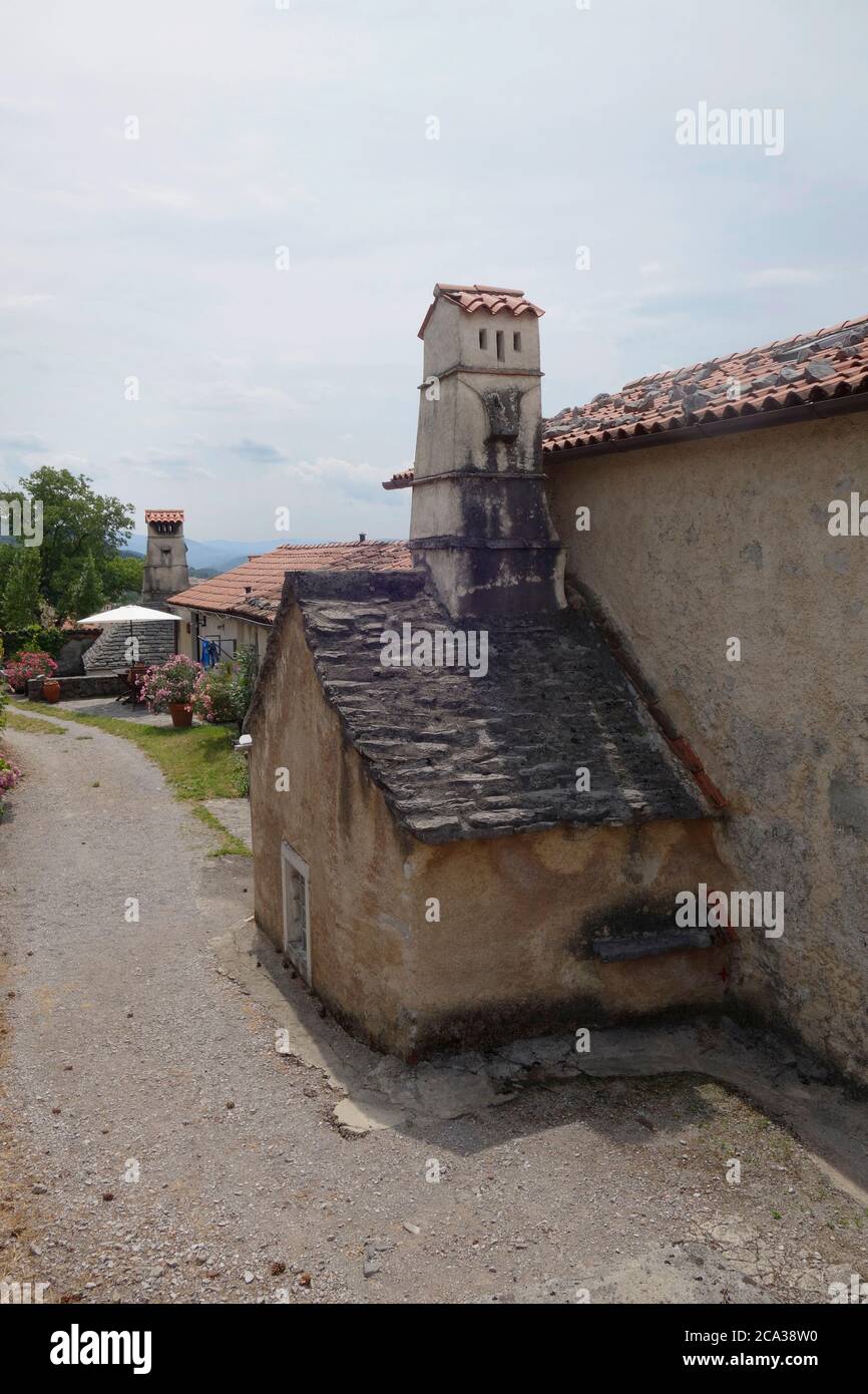 Rural medieval architecture. Village house with medieval (black) kitchen external extension. Štanjel village, Komen municipality, Kras region, Sloveni Stock Photo