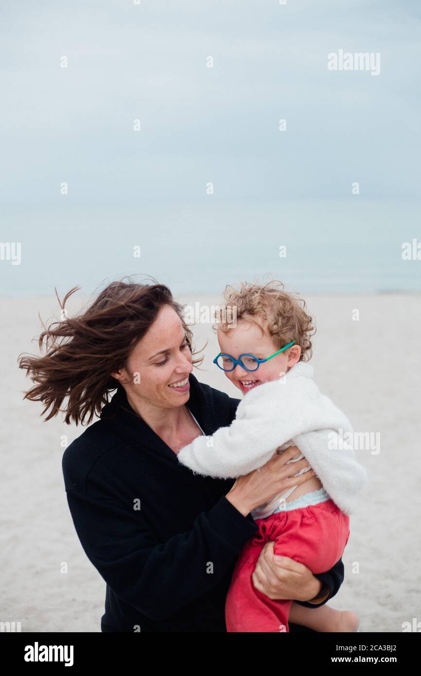 2 years old boy playing with his mother at the beach Stock Photo Alamy
