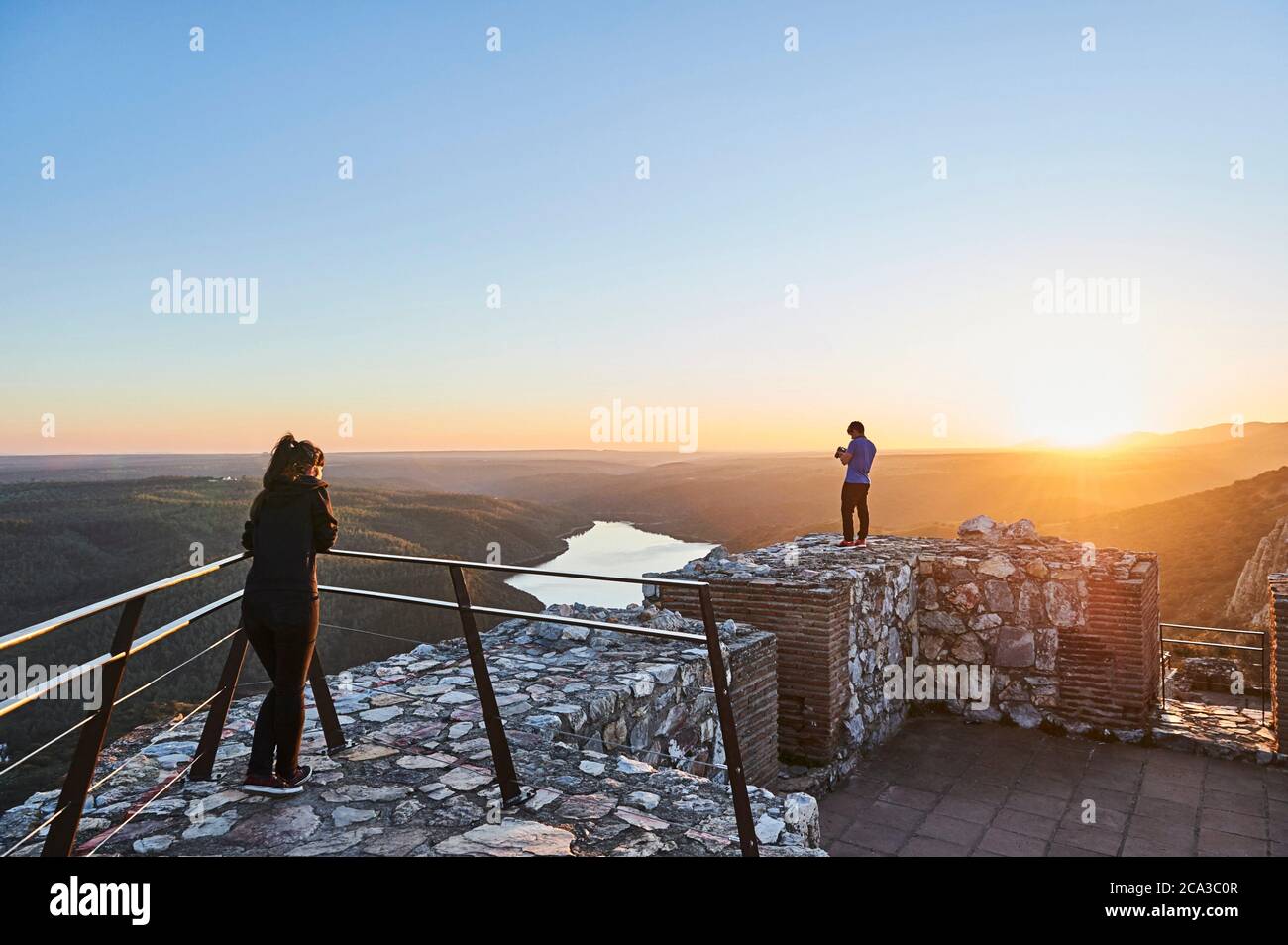 Young couple visiting Monfragüe Castle during sunset, Extremadura (Spain) Stock Photo