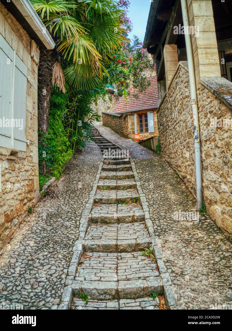 narrow street with stairs and medieval sandstone architecture, La Roque