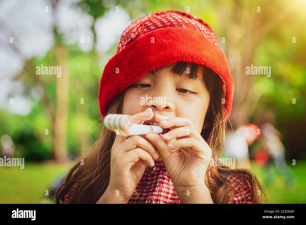 Happy little school girl playing in the garden. Stock Photo