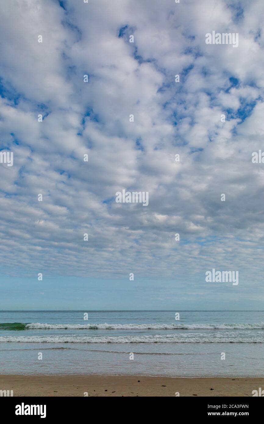 Blue sky with clouds over beach hi-res stock photography and images - Alamy