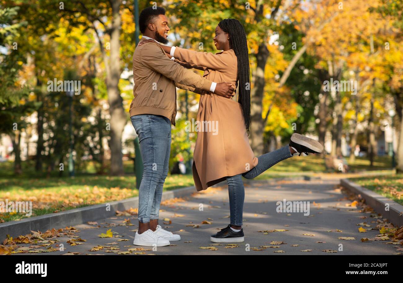 Loving Afro Couple Cuddling Outdoors, Standing On Alley In Autumn Park ...