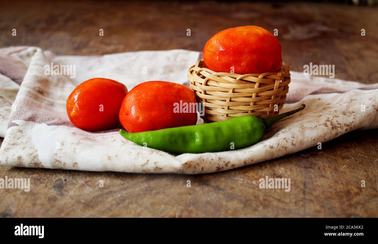 Still life with tomatoes and green chili Stock Photo Alamy