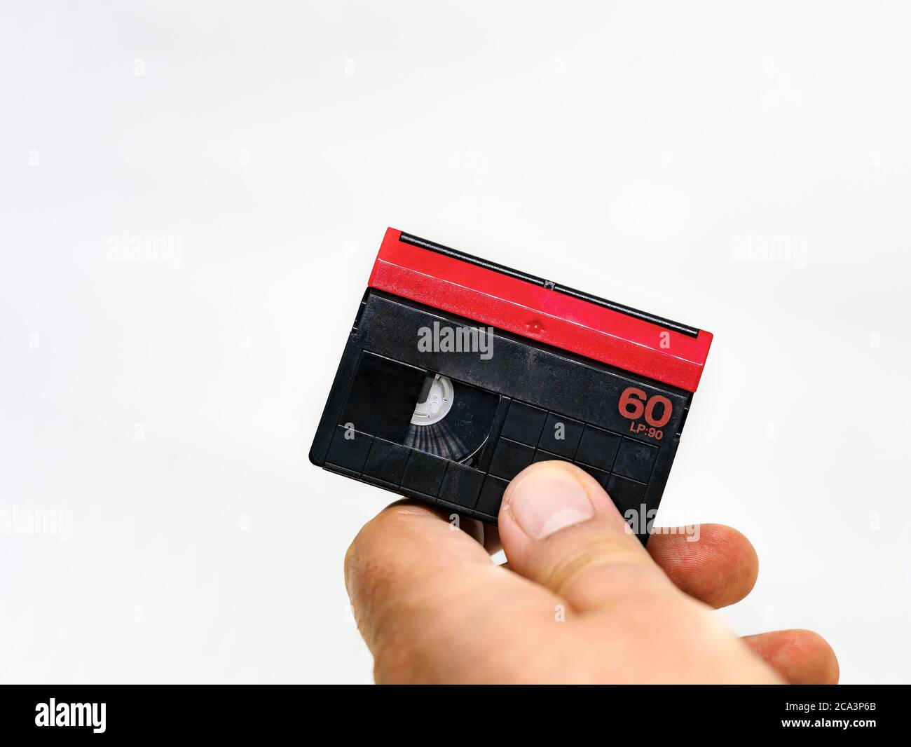male hand holding a Mini DV format video cassette isolated on a white  background. MiniDV cassettes had been intended for amateur use Stock Photo  - Alamy