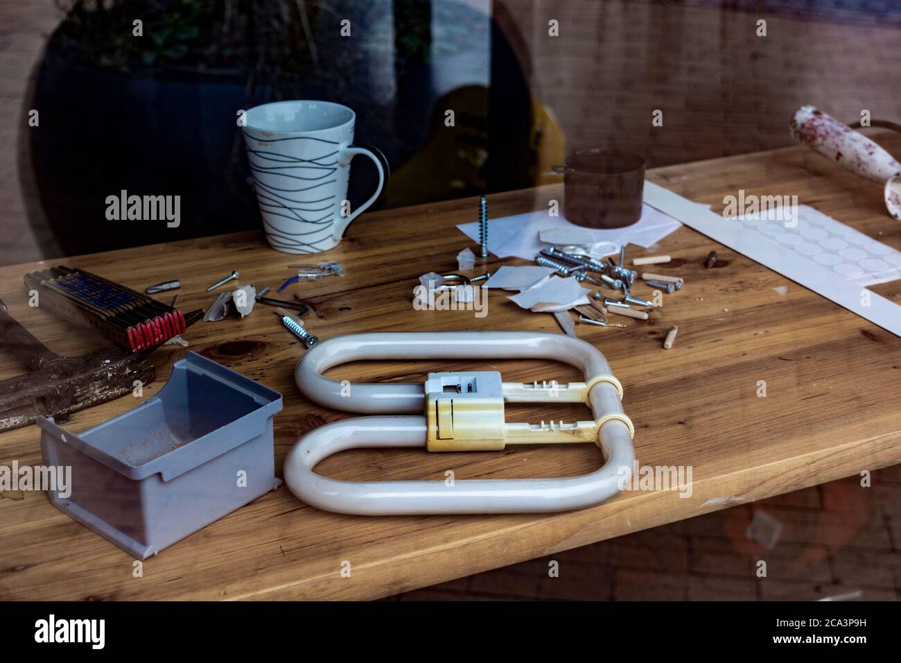 desktop in the workshop, tools lie on the table in the workshop. workshop table behind glass Stock Photo