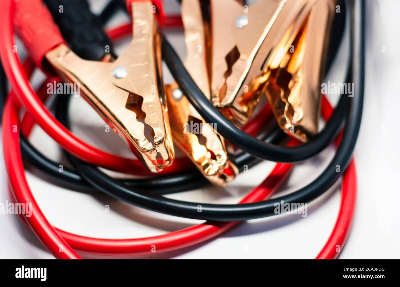 Close up of red and black car battery jumper cable, isolated on white  background. Boost cable. Focus on metal Stock Photo - Alamy