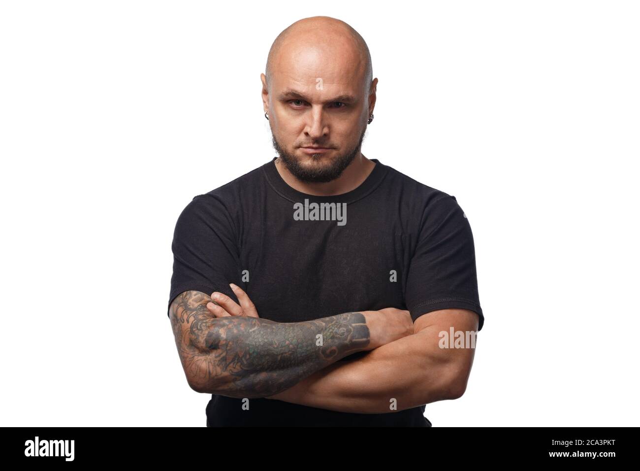 Photo of bald serious man in black shirt on white background Stock Photo