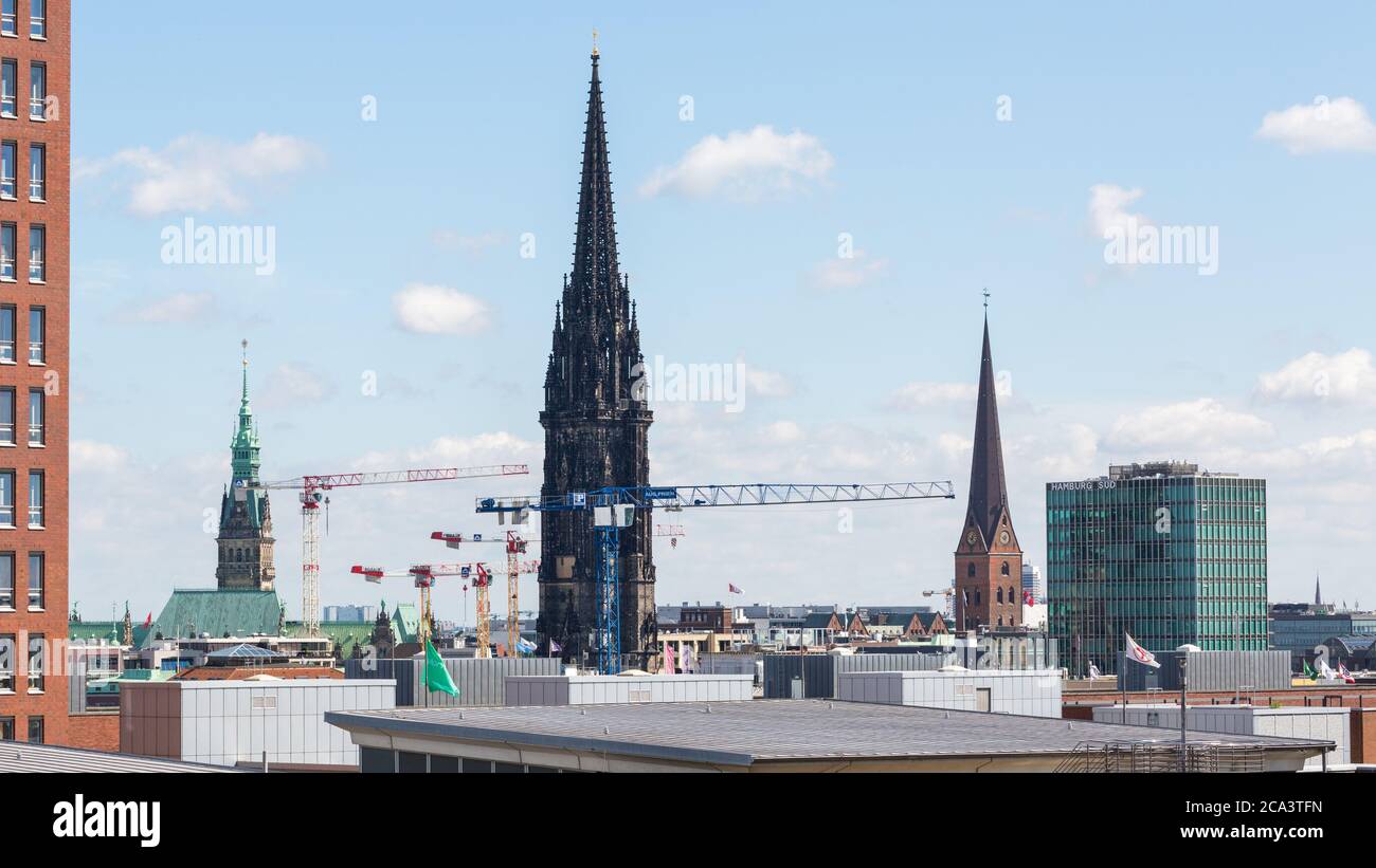 Cityscape of Hamburg with the steeple of church St. Nikolai. The ruins of the church are today a WWII memorial. Stock Photo
