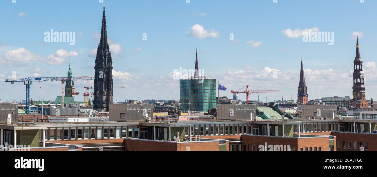 Cityscape of Hamburg with church St. Nikolai. Panorama format, cloudy sky. Stock Photo