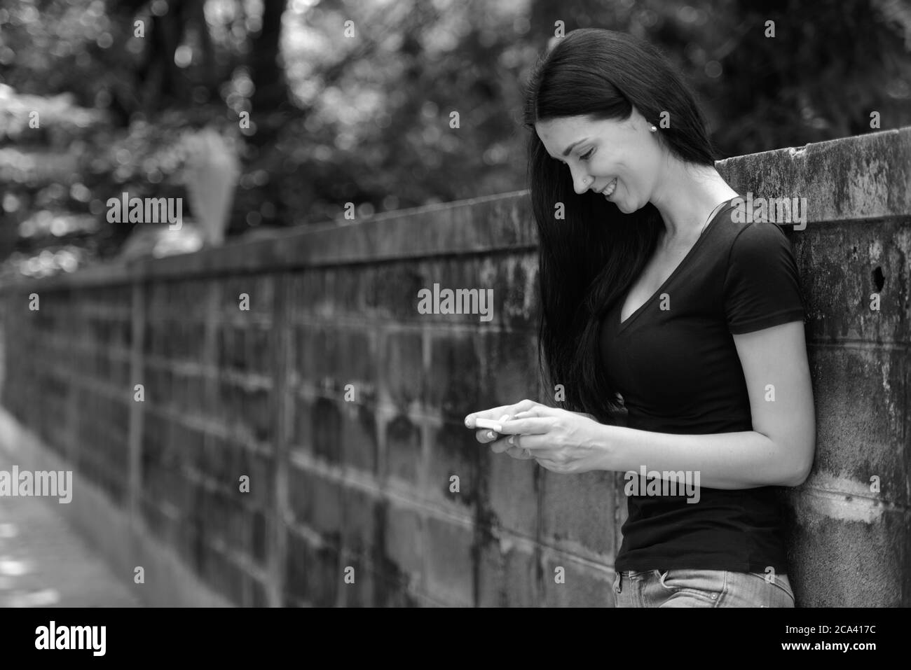 Portrait of happy beautiful woman outdoors in black and white Stock ...