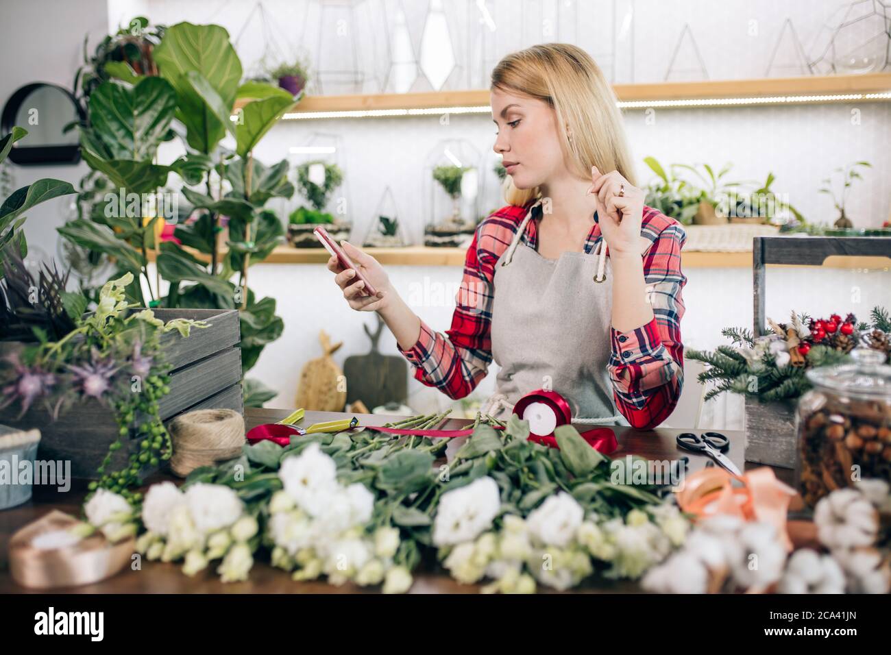 Small Business Owner Of A Retail Flower Shop And Garden Center Make Composition Of Flowers Woman Florist Entrepreneur Shopkeeper Pruning And Trimming Stock Photo Alamy