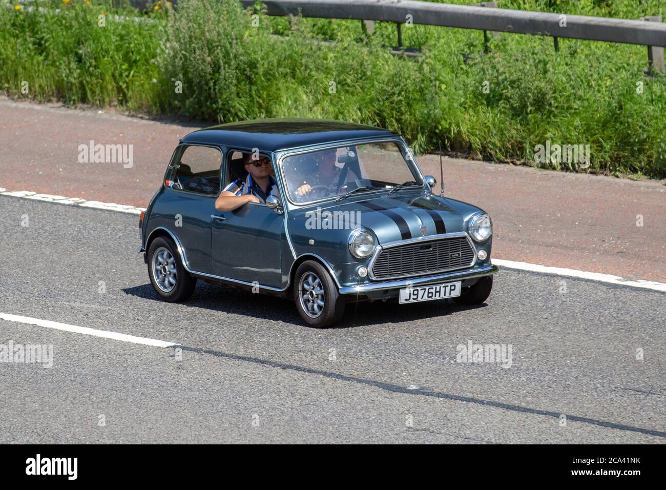 1991 90s blue Rover Mini Neon; Vehicular traffic, moving vehicles, small cars, vehicle driving on UK roads, 2dr motors, motoring on the M6 motorway highway UK road network. Stock Photo