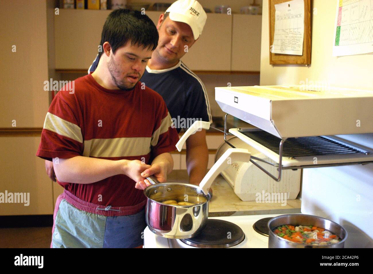 Man with learning disability cooks his own meal in a sheltered housing