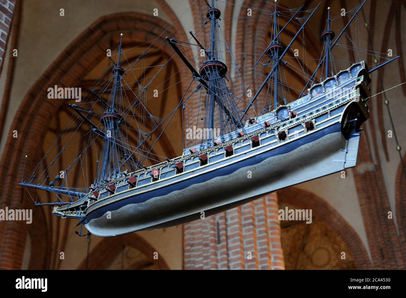 Sweden, Stockholm. English Galleon, 16th century. Votive ship hanging from the ceiling of the Cathedral of Saint Nicholas. One of the oldest votive ships in the world. This ship model is a copy of the original made in 1950s. The original ship model was built around 1600, today kept in the Museum of Maritime History in Stockholm. The ship-type is an Elizabethan galleon, as at the end of the 15th century. Stock Photo