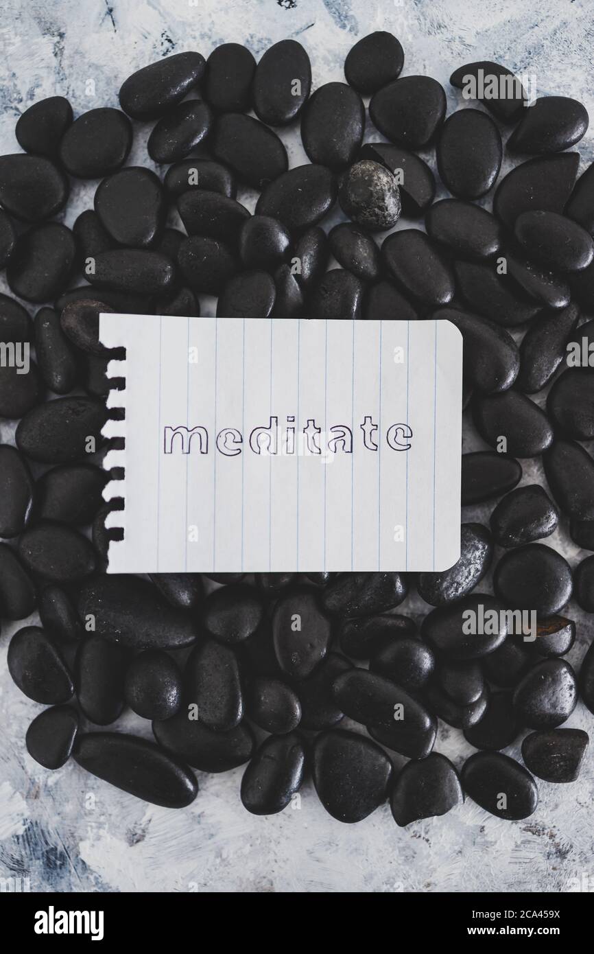 mental health concept, notepad with text Meditate on zen pebbles on ...