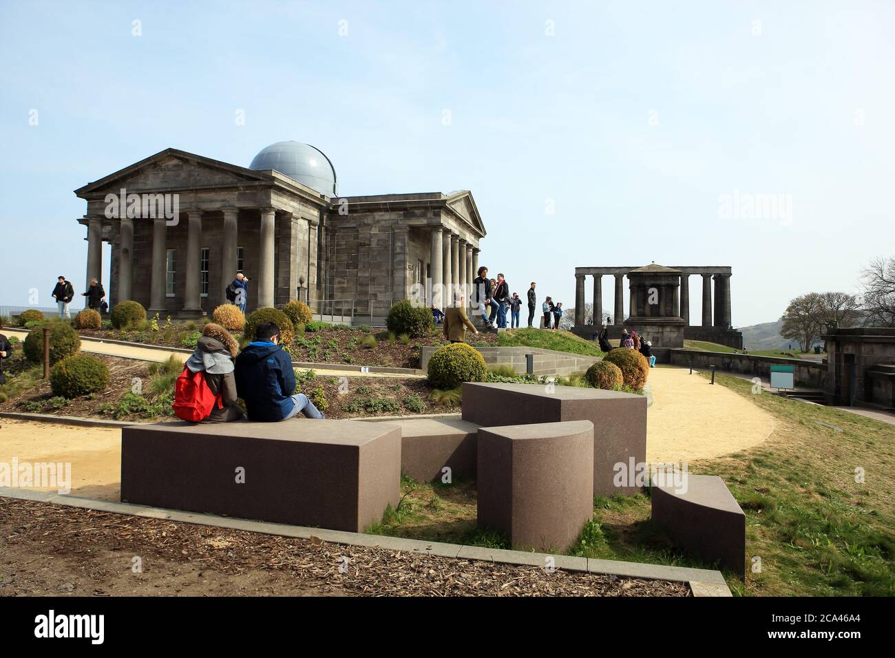 Visitors admiring Edinburgh's City Observatory on Calton Hill with the Playfair Monument directly in front of the National Monument Stock Photo
