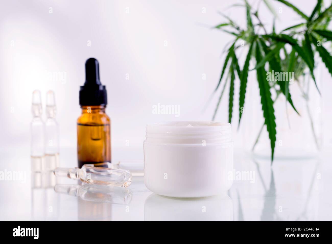 Download Natural Cosmetics With Cannabis Oil Mockup With A White Clean Jar With Cosmetics Cream And Fresh Green Leaves Of Hemp Stock Photo Alamy
