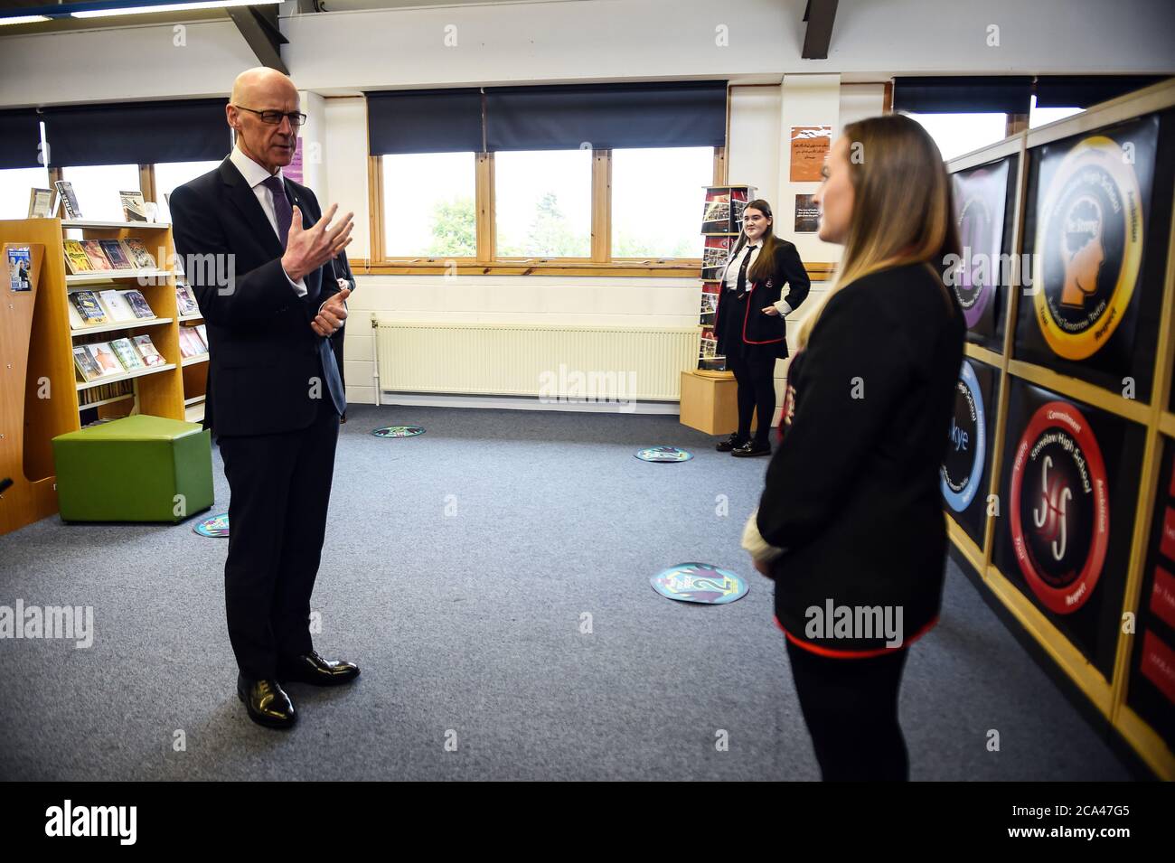 Deputy First Minister of Scotland and Cabinet Secretary for Education and Skills John Swinney speaks with pupils during a visit to Stonlelaw High School in Rutherglen, Glasgow, on the day pupils are finding out their Scottish Qualifications Authority (SQA) grades. Stock Photo