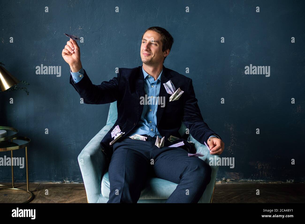 Young man paper planes made of money. Entrepreneur or investor, development planning and financial strategies. Stock Photo