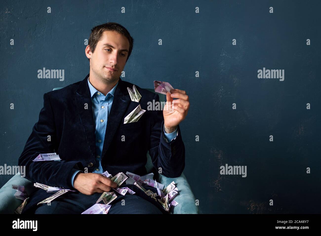 Young man paper planes made of money. Entrepreneur or investor, development planning and financial strategies. Stock Photo