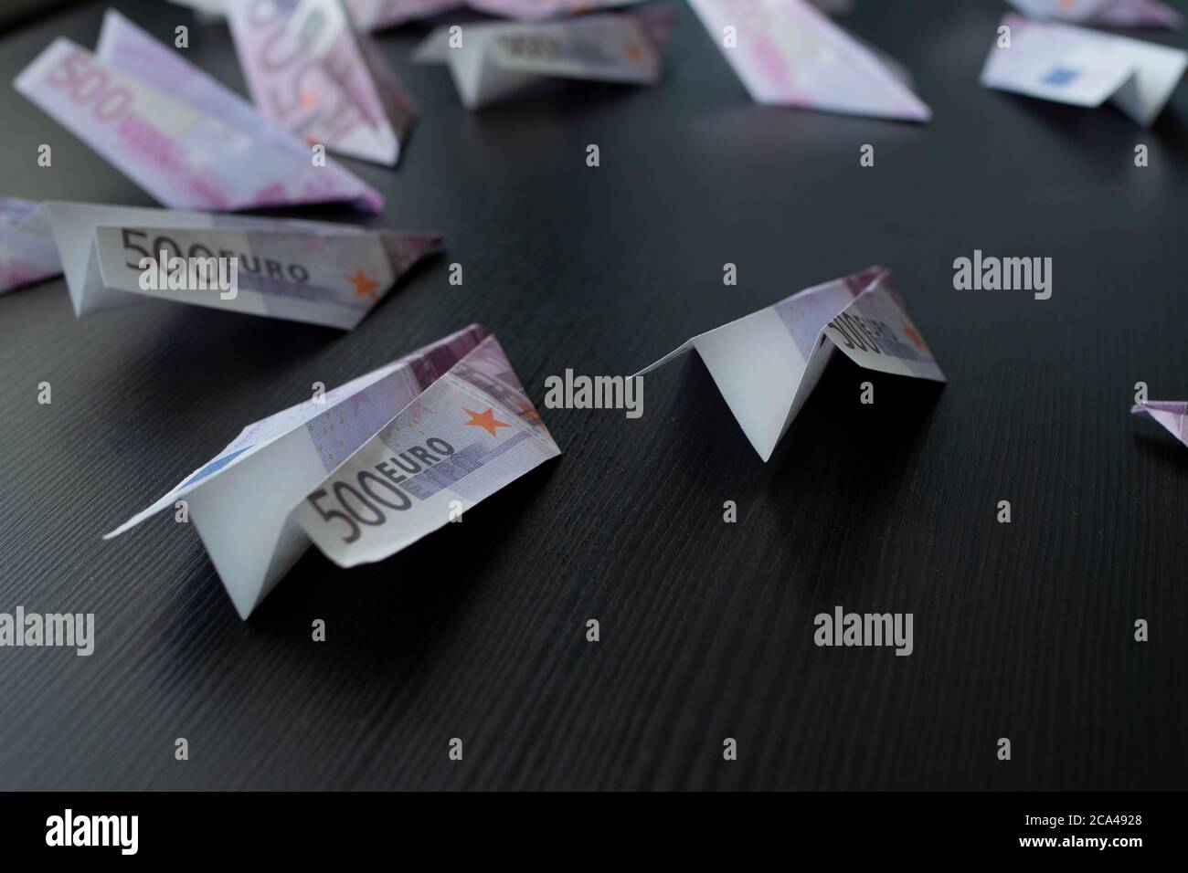 Paper airplanes made of Euro banknotes, the concept of cash flow. Global financial crisis, debt on loans, concept. Stock Photo