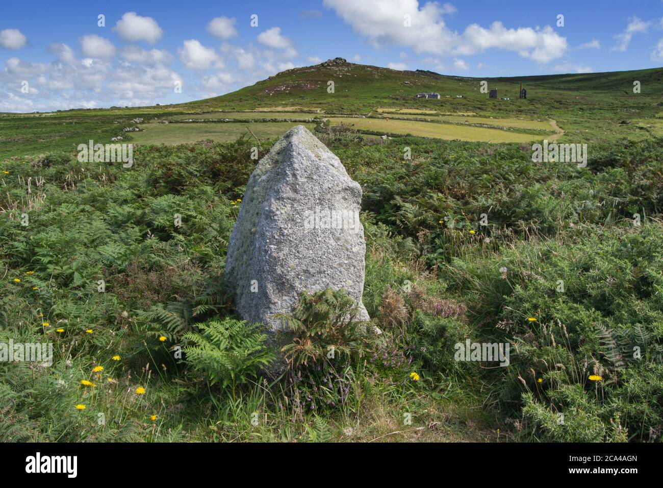 A Small Standing Stone near Bosigran Castle, Carn Galva Hill and Engine House in the Background Stock Photo
