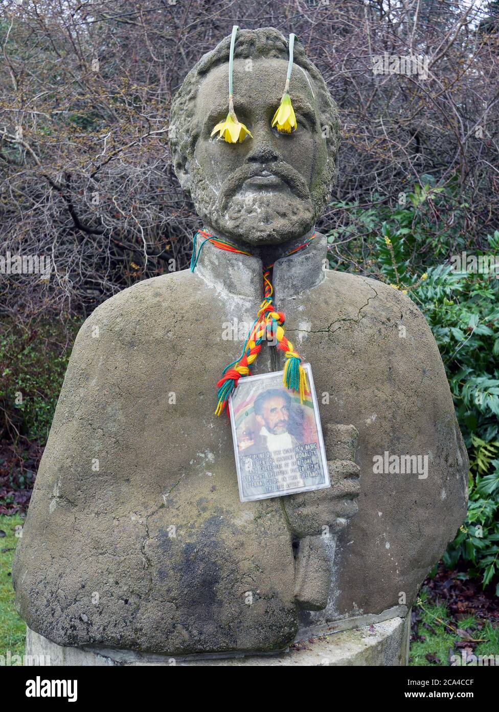 Statue of Haile Selassie in Cannizaro Park, with Daffodils Co ring his eyes, Wimbledon, London SW19. Stock Photo