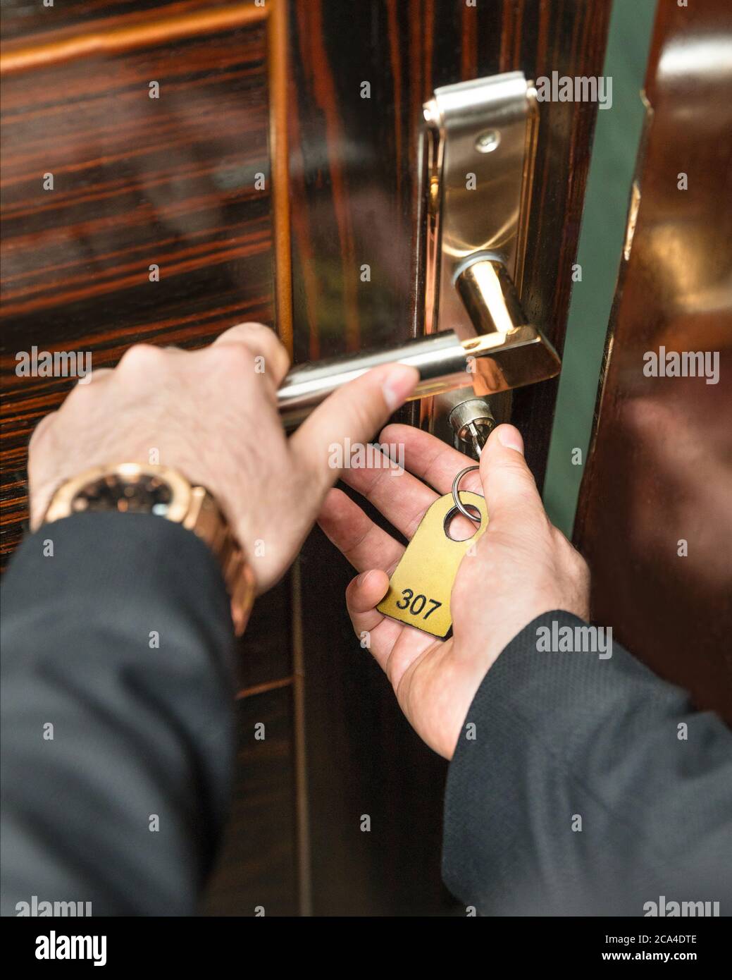 Opening the hotel room door with a key Stock Photo Alamy
