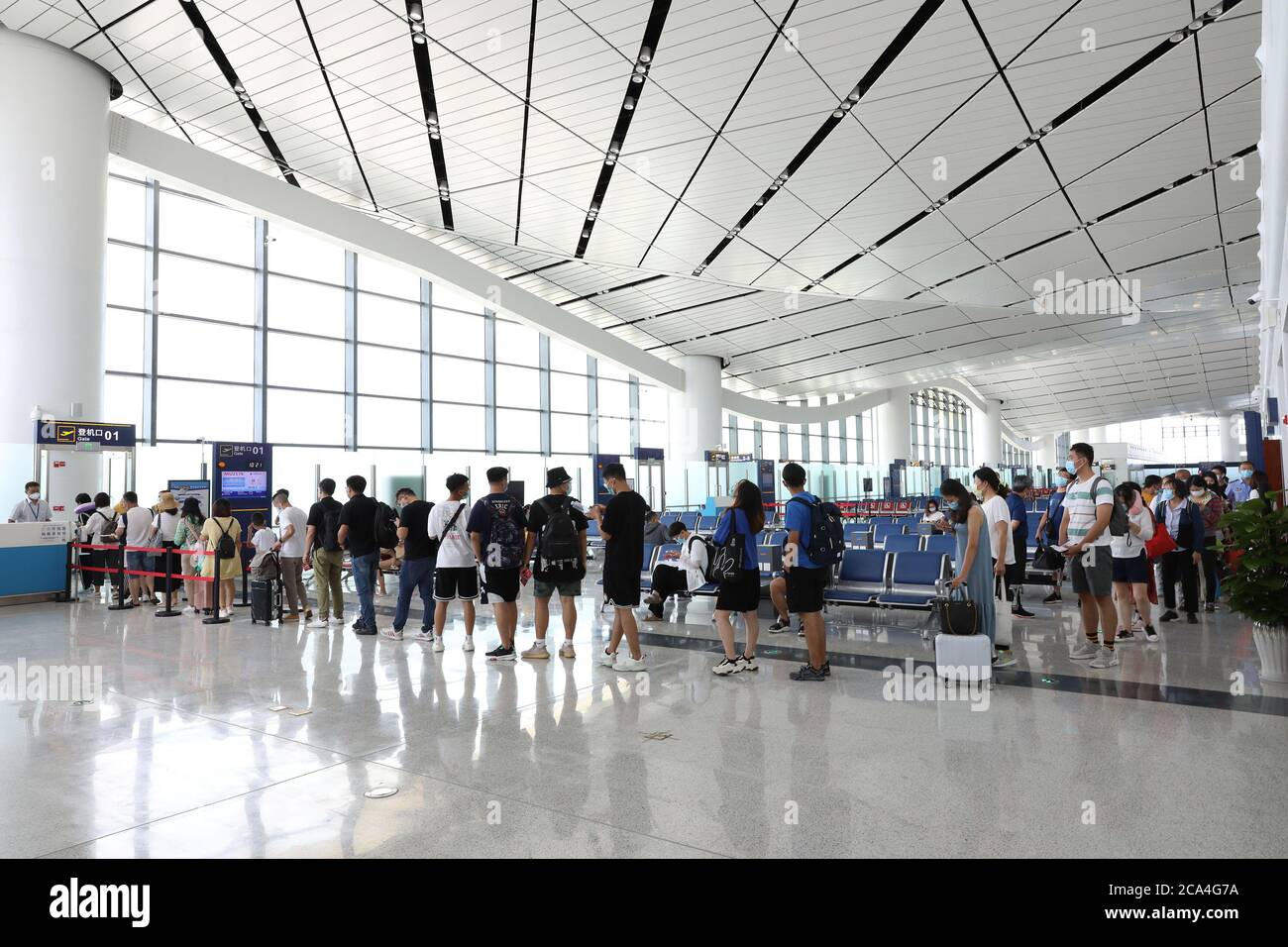 Zhangjiakou, China's Hebei Province. 4th Aug, 2020. Passengers wait for boarding at Terminal 2 of the extended Zhangjiakou Ningyuan Airport in Zhangjiakou, north China's Hebei Province, Aug. 4, 2020. The extended Zhangjiakou Ningyuan Airport, one of the key supporting infrastructure developments for the 2022 Beijing Winter Olympics, was completed and put into service on Monday. The expansion project includes a new terminal, an emergency rescue center, an apron, and an extended runway, among others. Credit: Wu Diansen/Xinhua/Alamy Live News Stock Photo