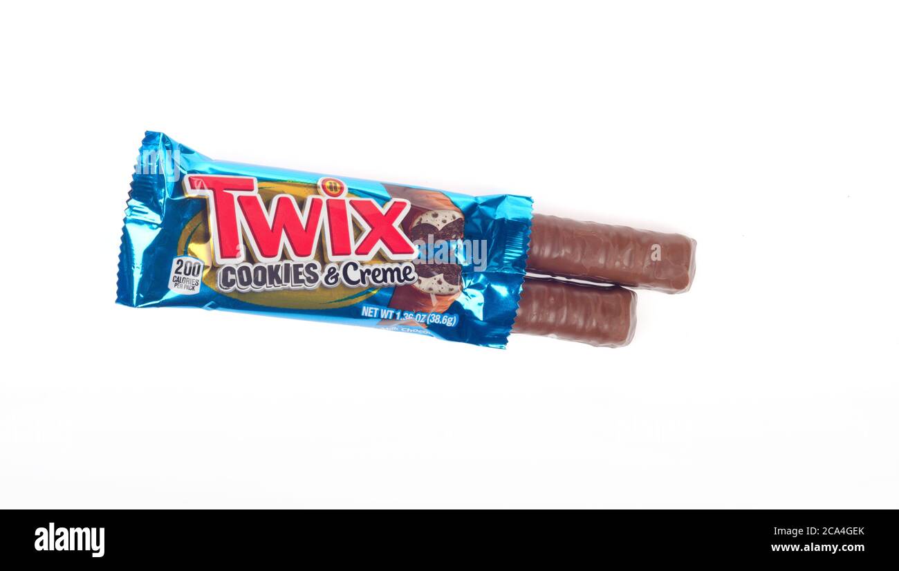 Twix Cookies & Creme Candy Bar with wrapper opened showing milk