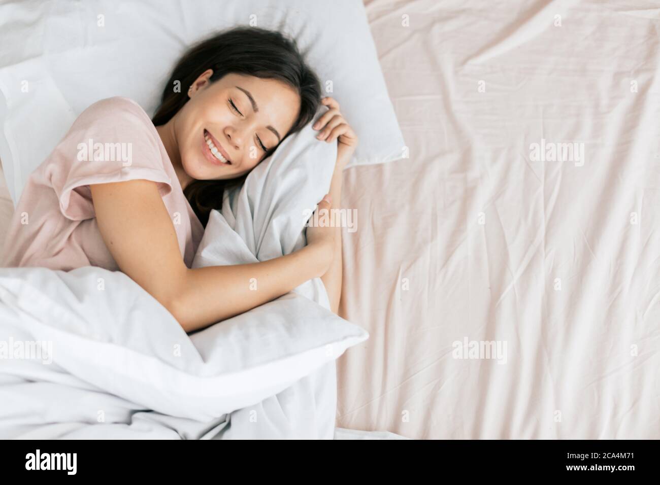 nice girl is laughing while sleeping, top view phoro. copy space. Stock Photo