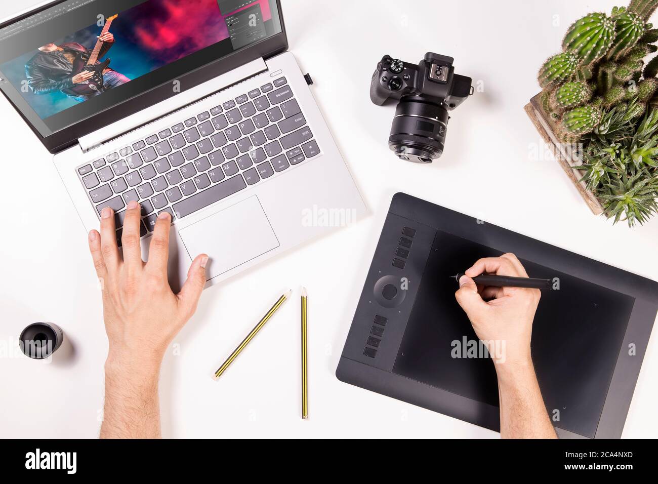 Photographer and graphic designer works on laptop. Flat lay top view of