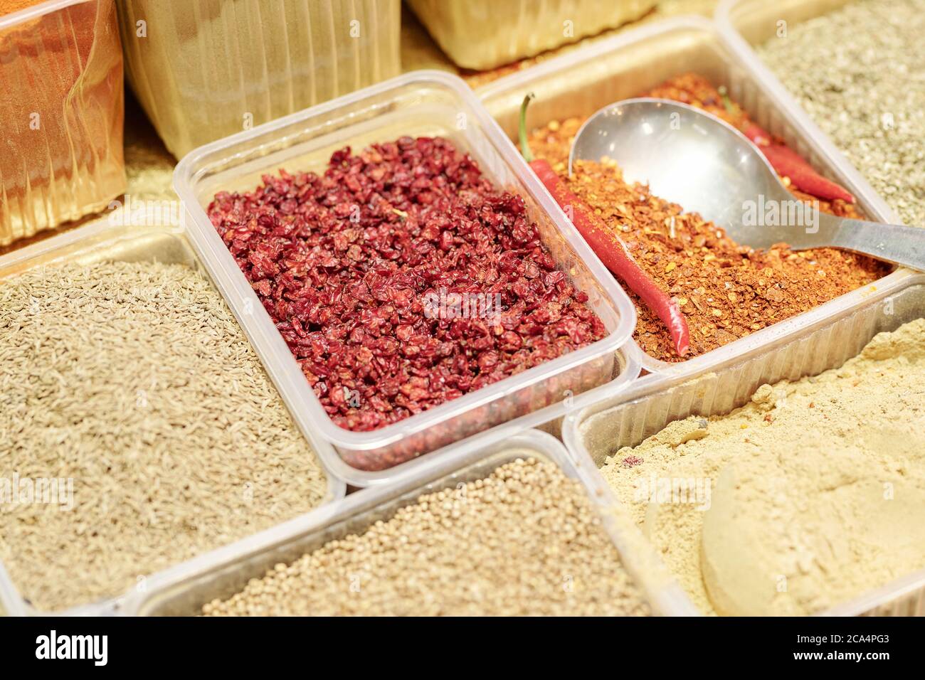 Close-up of various spices in disposable containers used for cooking savory dishes at food market Stock Photo