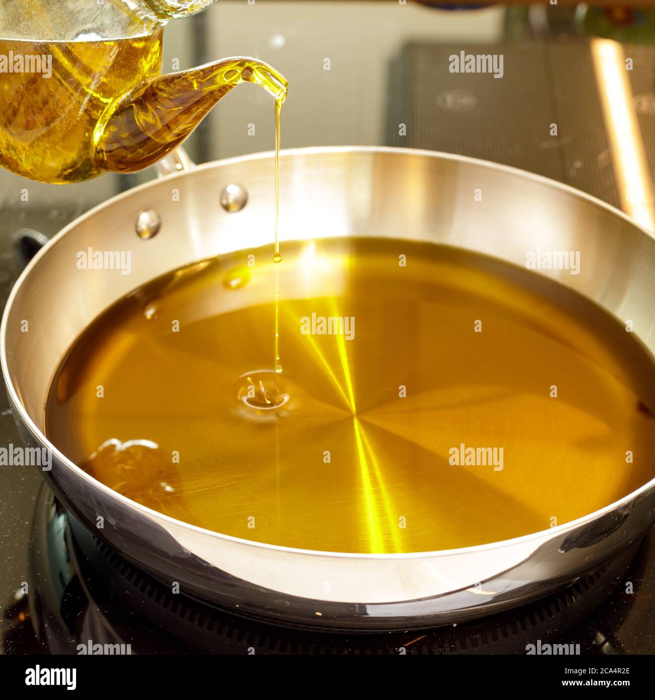 Oil pouring into a pan hires stock photography and images Alamy