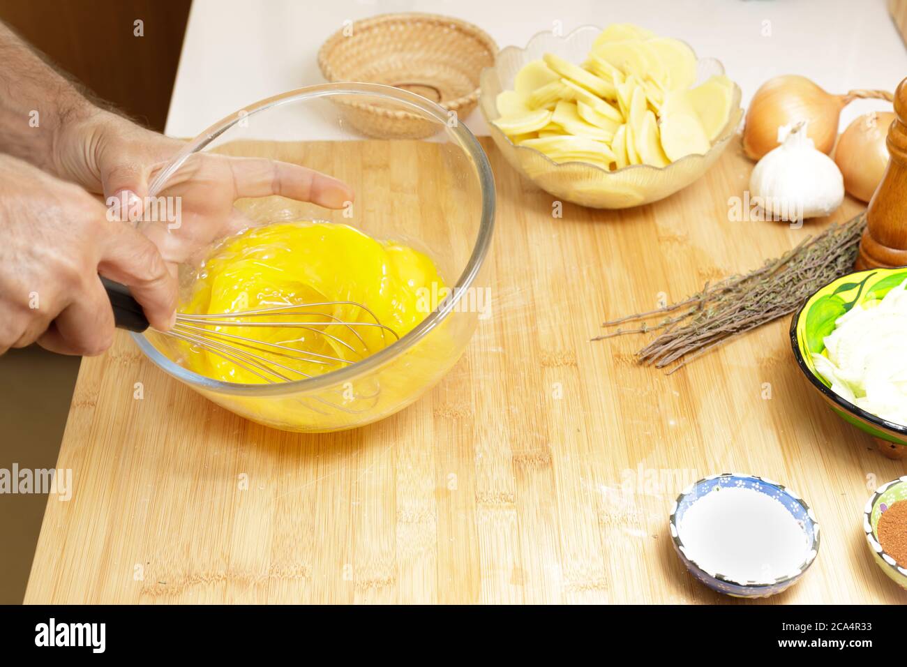 Whisk eggs to prepare a spanish omelette Stock Photo Alamy