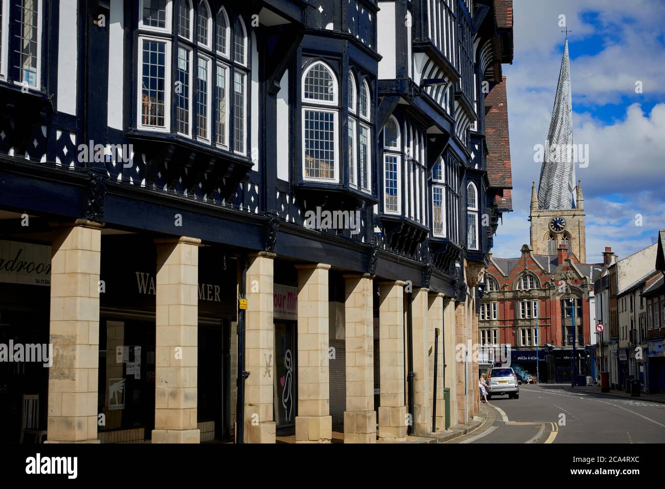 Chesterfield town centre in Derbyshire landmark Chesterfield Parish Church with iconic crooked spire along Knifesmithgate tudor row Stock Photo