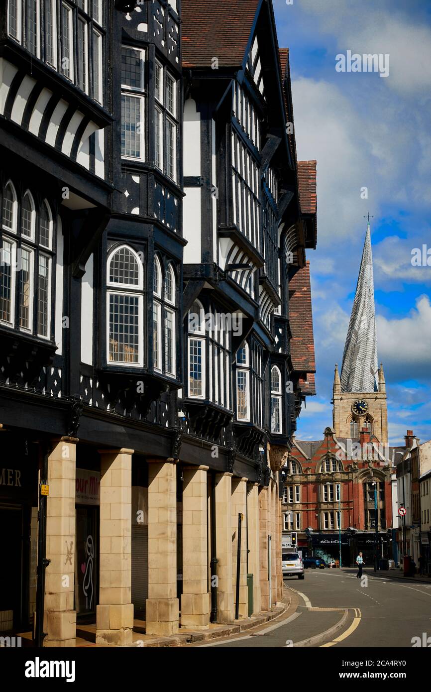 Chesterfield town centre in Derbyshire landmark Chesterfield Parish Church with iconic crooked spire along Knifesmithgate tudor row Stock Photo