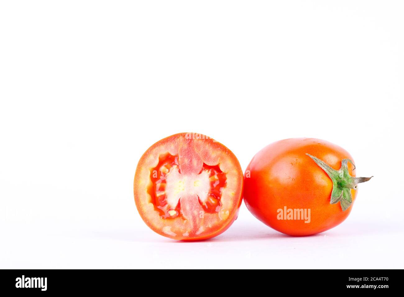 Red tomato  vegetables are used as the primary ingredient in cooking on the white background isolated Stock Photo