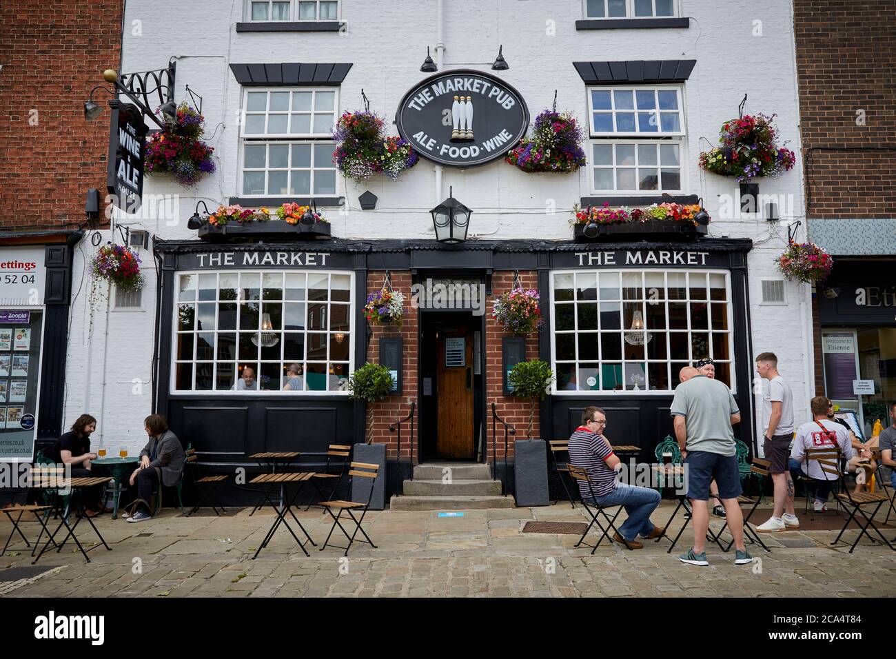 Chesterfield town centre in Derbyshire The Market Pub pavement drinking and pretty hanging basket flowers Stock Photo