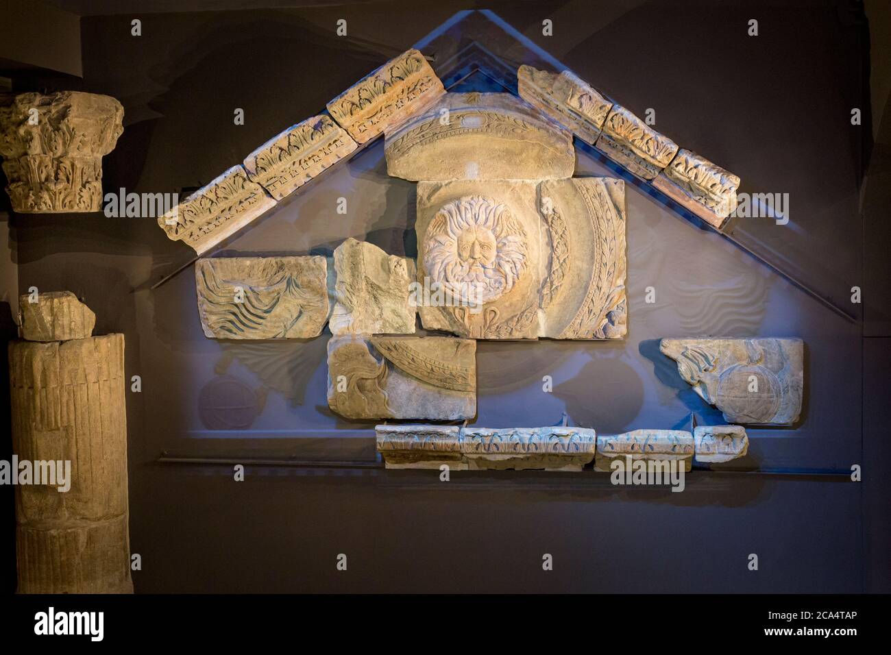 Remains of the Temple Pediment - Gorgon's Head, the likeness of goddess Sulis Minerva on display, the Roman Baths Museum, Bath, Somerset, England, UK Stock Photo