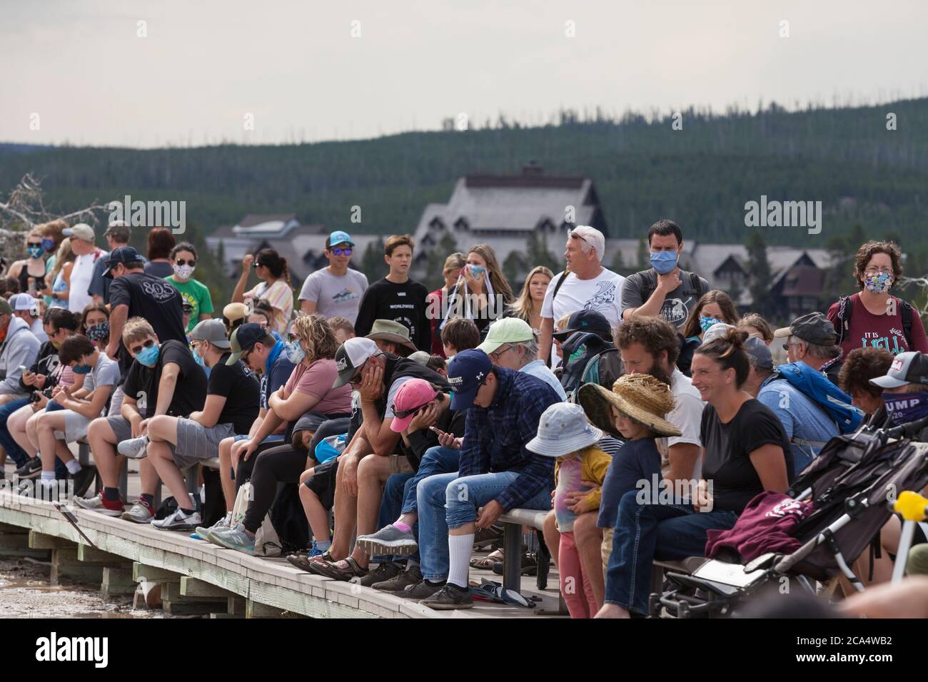 Visitors crowd the boardwalk while waiting for Grand Geyser to erupt on Monday, August 3, 2020. The park recently reported several positive cases of the COVID-19 virus among visitors and concessioners. Stock Photo
