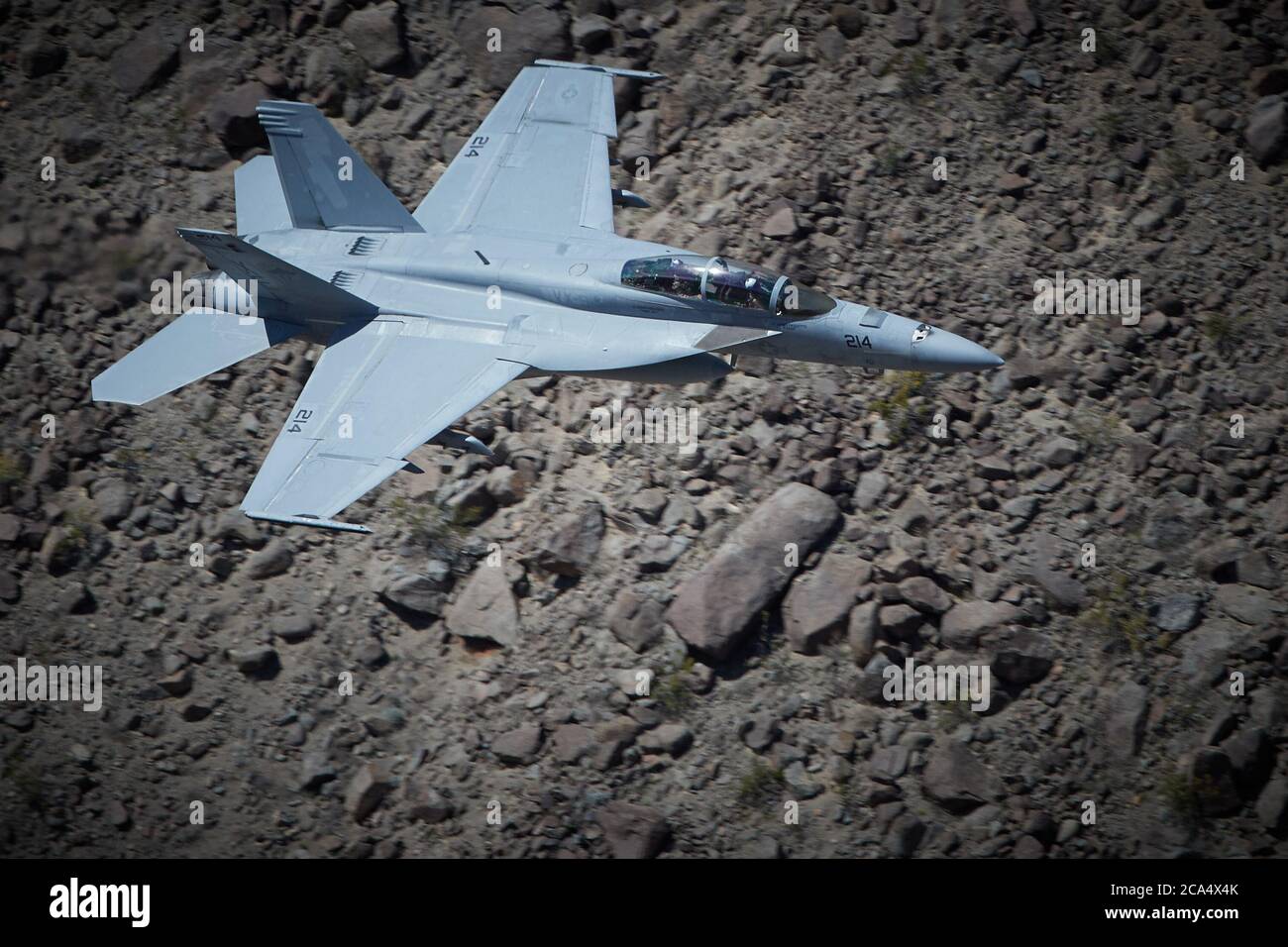 United States Navy F/A-18F Super Hornet Jet Fighter, Flying At Low Level And High Speed Along Rainbow Canyon, California, USA. Stock Photo