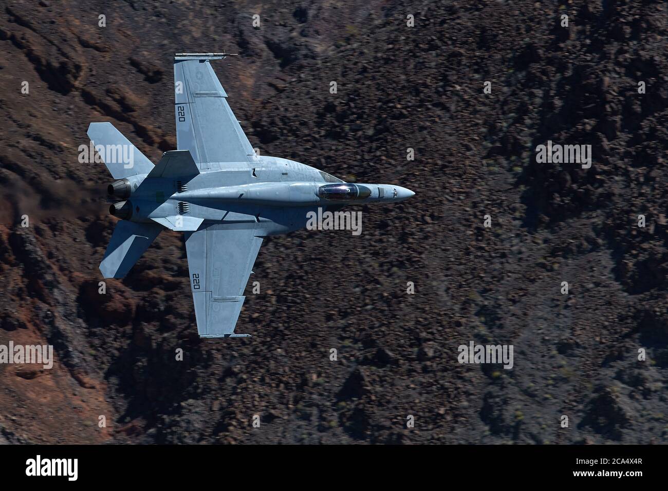 United States Navy F/A-18E Super Hornet Jet Fighter Flying At High Speed And Low Level. Through A Desert Canyon. Stock Photo