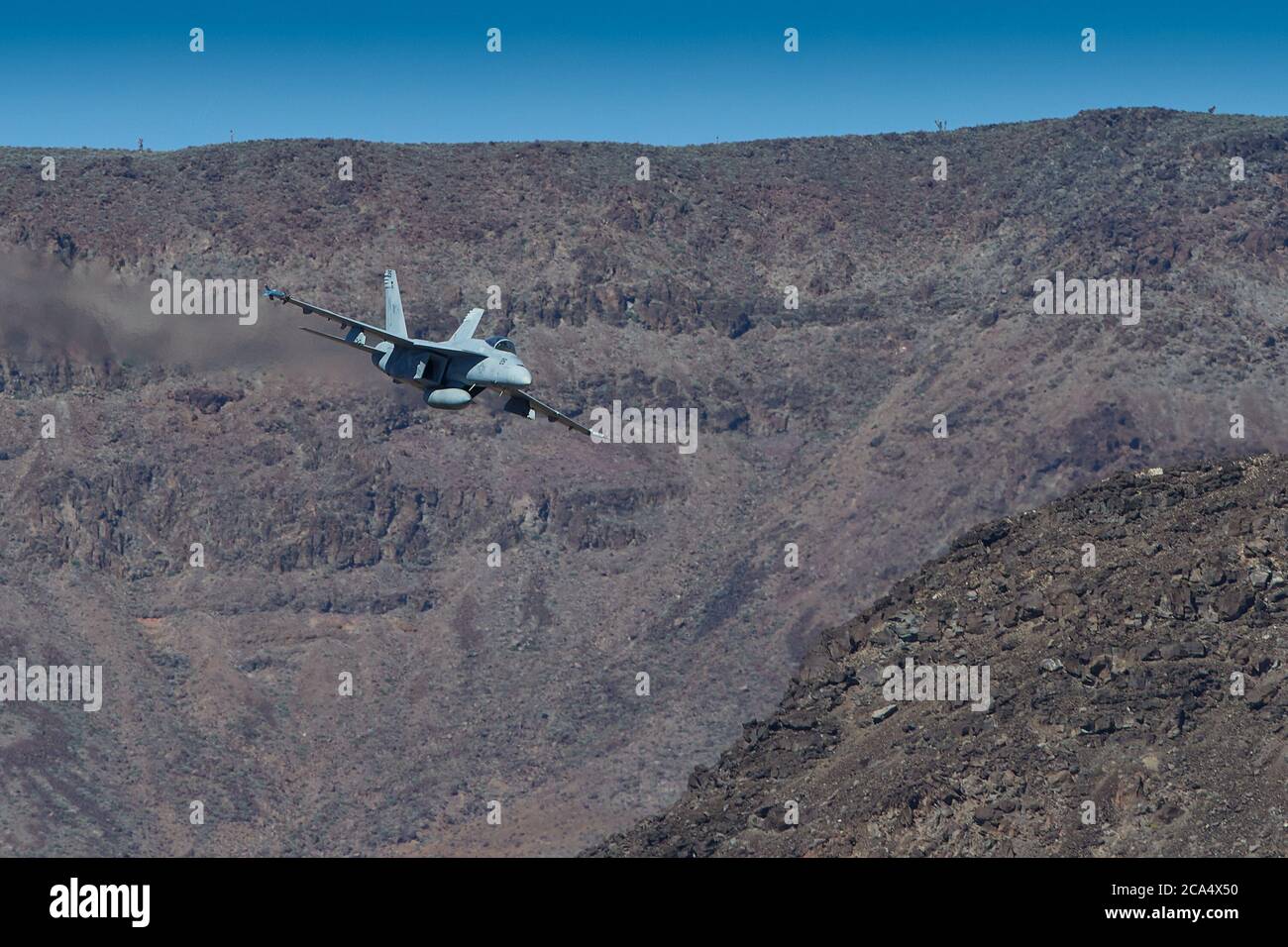 United States Navy F/A-18E Super Hornet Fighter Jet, Flying At High Speed And Low Level. Through A Desert Canyon. Stock Photo