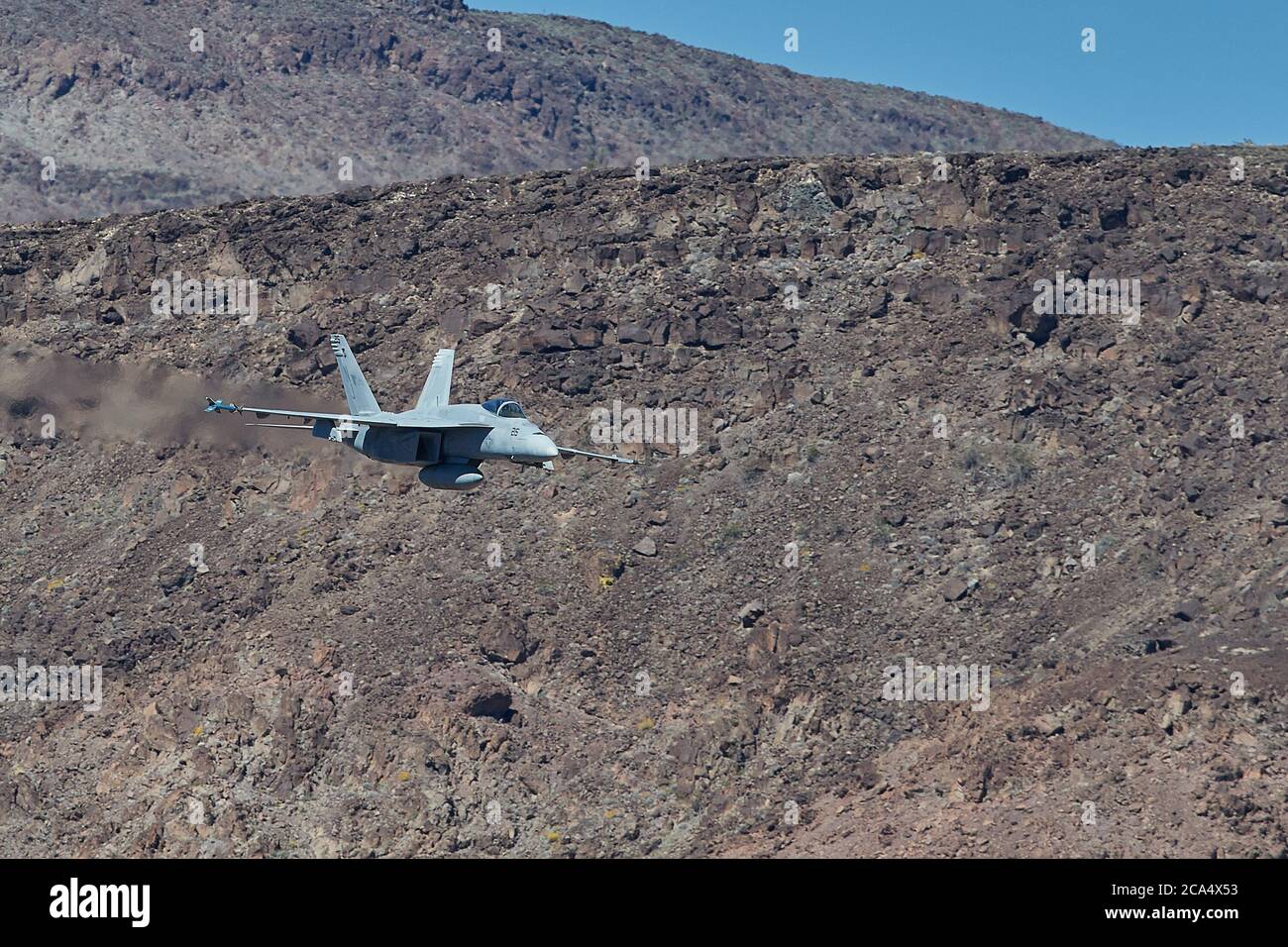 United States Navy F/A-18E  Super Hornet Fighter Jet, Flying At High Speed And Low Level. Through A Desert Canyon. Stock Photo