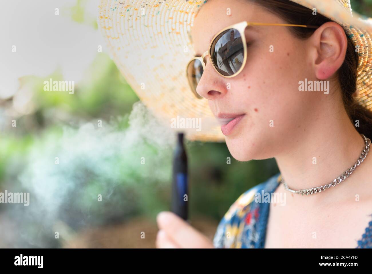 Young attractive woman vaping Stock Photo