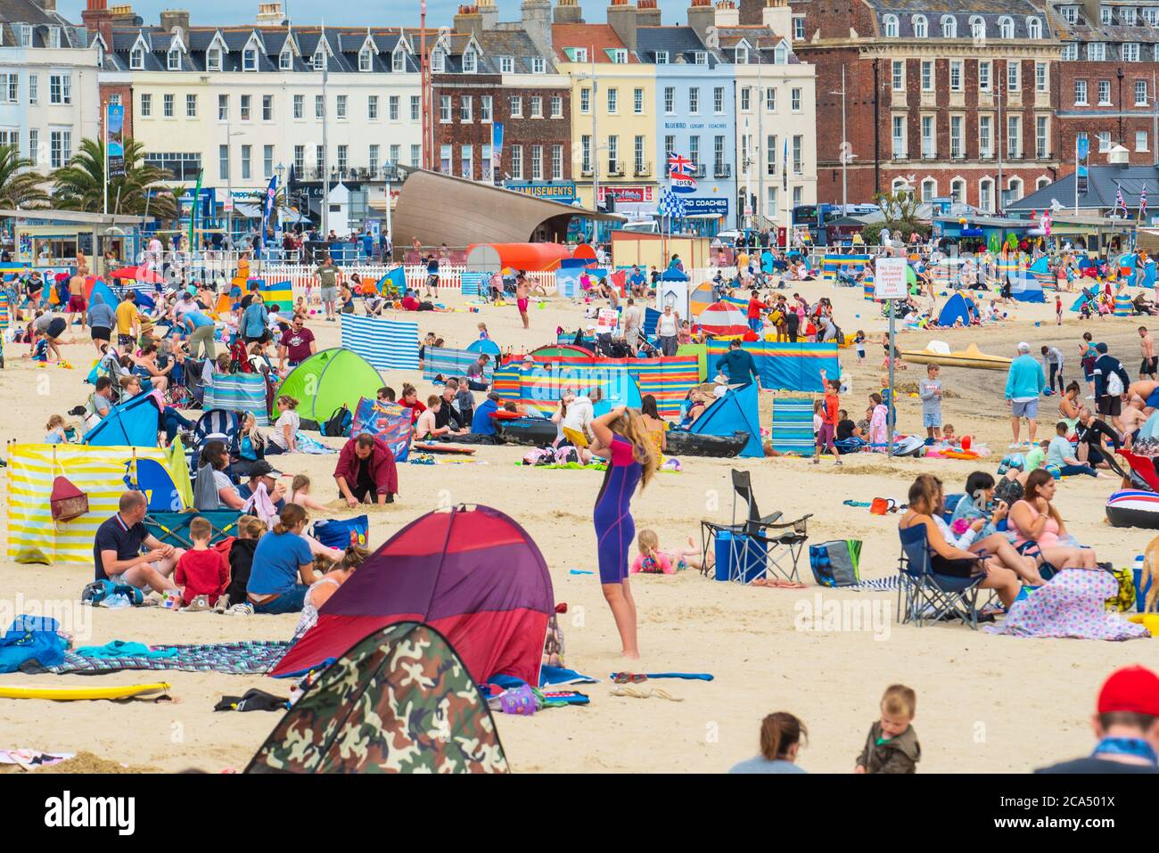 Weymouth, Dorset, UK. 4th Aug, 2020. UK Weather: The sandy beach at Weymouth was busy today as holidaymakers and beachgoers enjoyed hot sunny spells and a light breeze. Credit: Celia McMahon/Alamy Live News Stock Photo