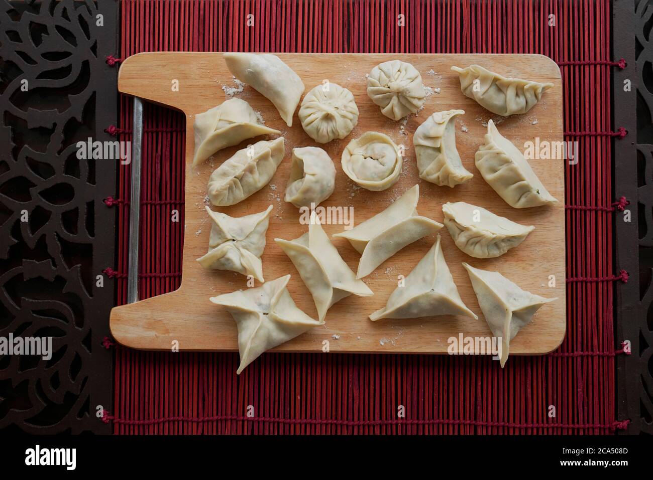 VEGETARIAN DIM SUM UNCOOKED WITH CHILLI OIL AND SCHEZWAN SAUCE Stock