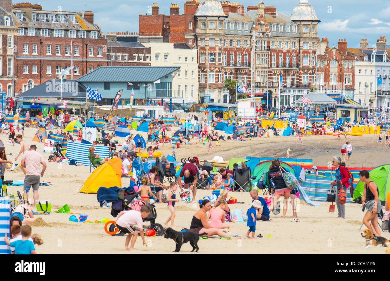 Weymouth, Dorset, UK. 4th Aug, 2020. UK Weather: The sandy beach at Weymouth was busy today as holidaymakers and beachgoers enjoyed hot sunny spells and a light breeze. Credit: Celia McMahon/Alamy Live News Stock Photo